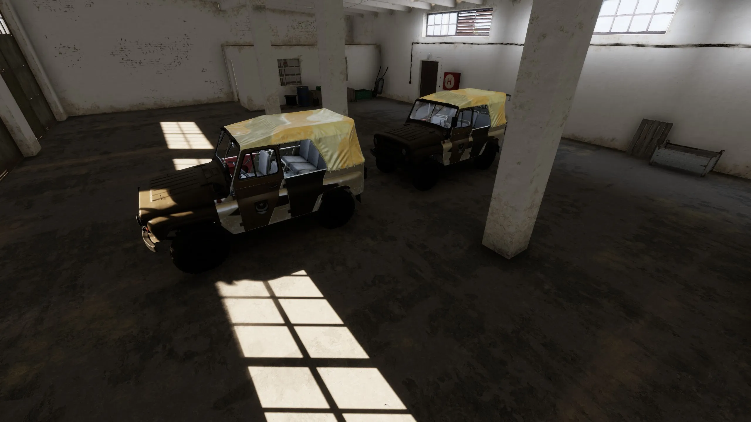 Two UAZ type vehicles parked in a garage.