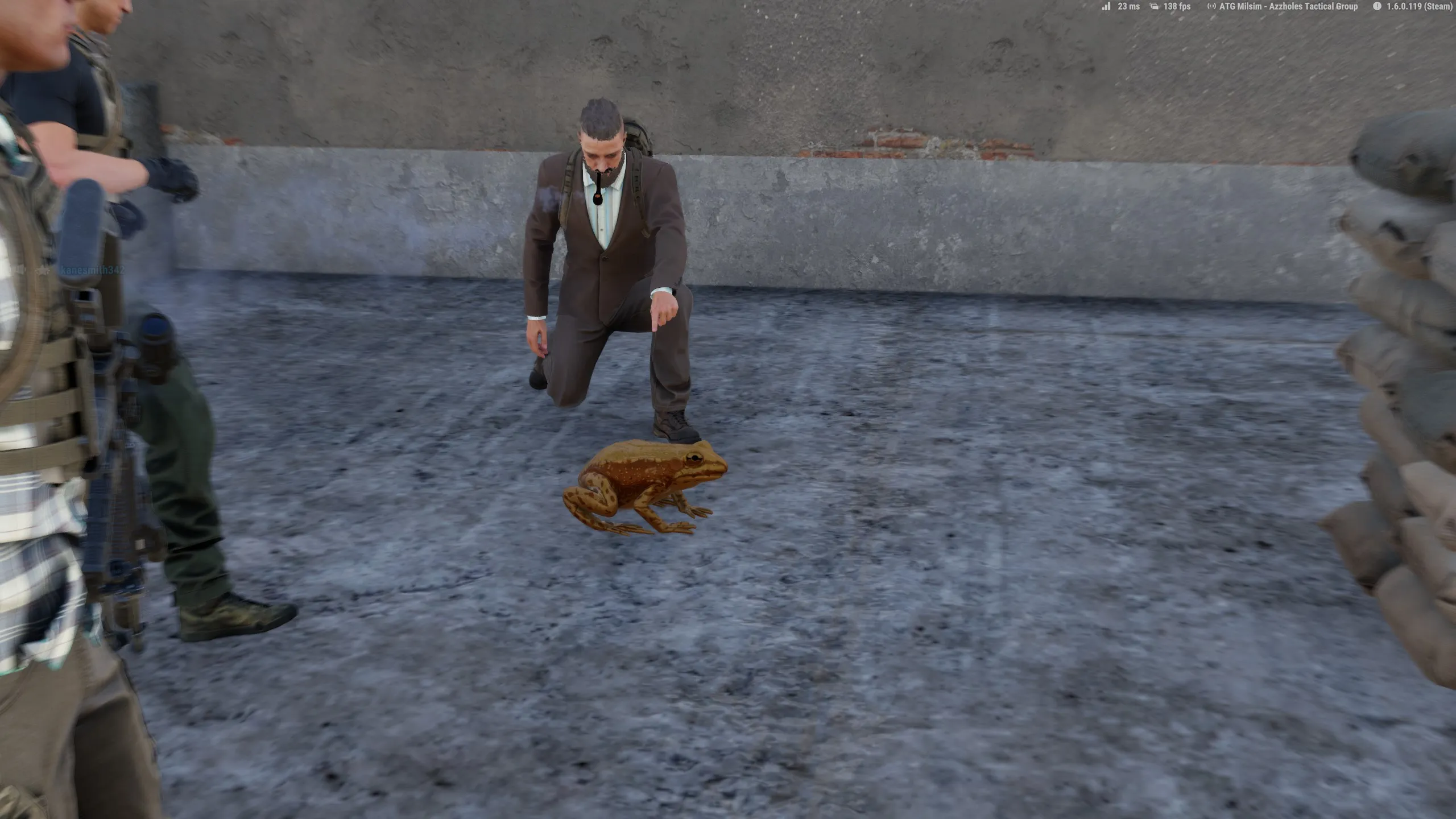 A man in a brown suit pointing to a golden frog